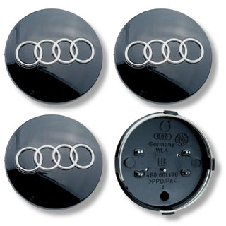 Set of alloy wheel centre caps showing front and back sides.
